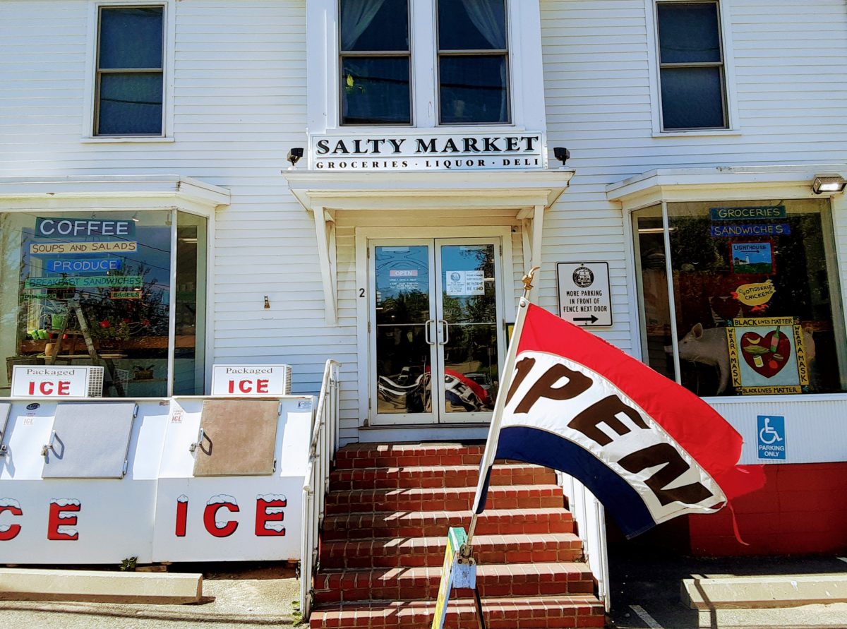 The front of the Salty Market with ice machine and open flag