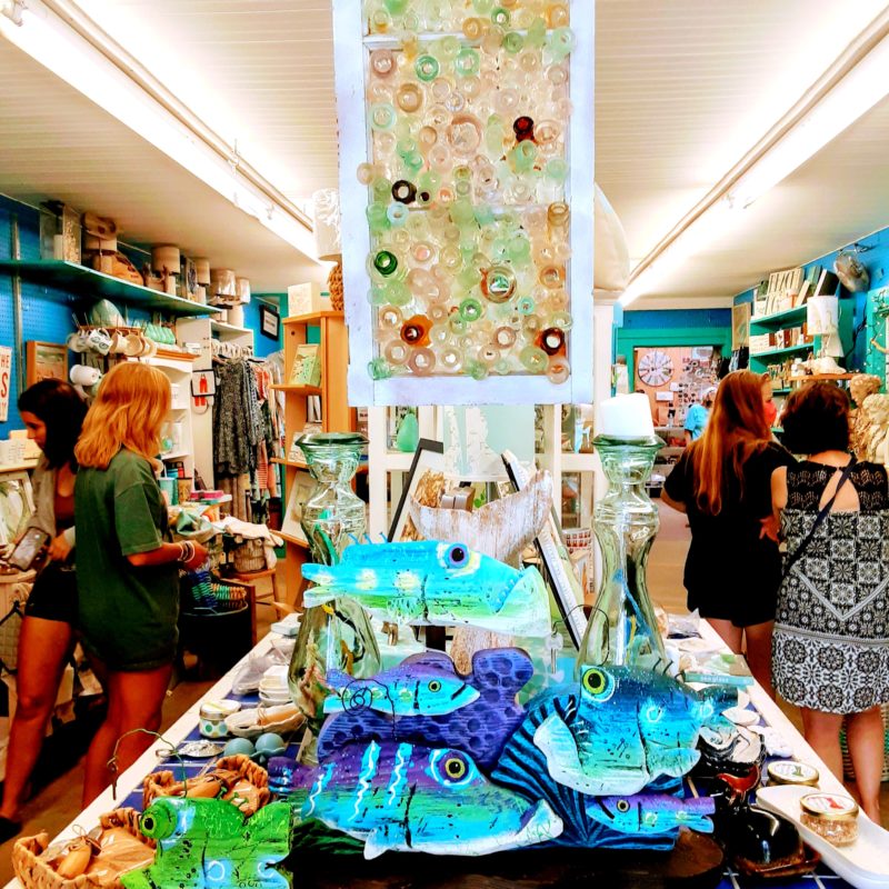A store full of nautical gifts and a seaglass window are shown