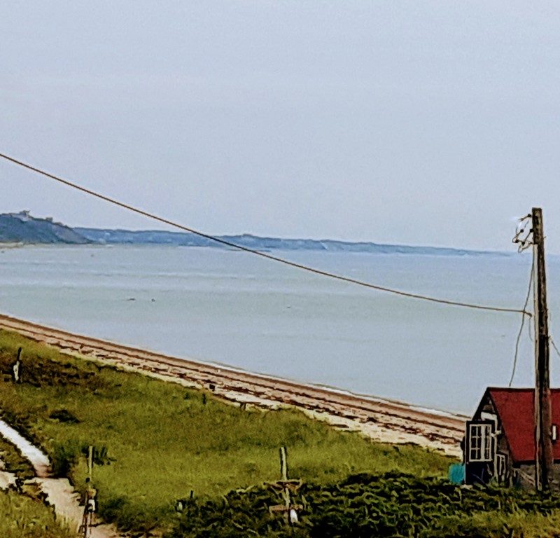 A beach is shown from high on a hill